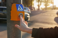 person presses button at traffic light to stop movement of cars and safely cross road intersection - PhotoDune Item for Sale