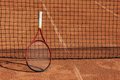 tennis racket is at net tennis court made of red clay soil with markings for game or competition - PhotoDune Item for Sale