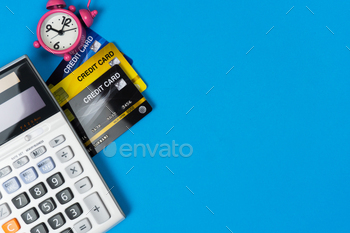  clock and calculator on black background from top view.