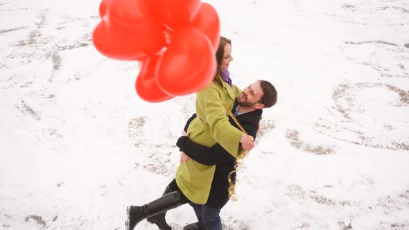 Happy Man Hugs His Beloved Woman and Circles Around Himself While Standing in an Outdoor Park on a