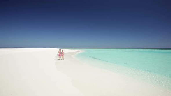 Loving Couple Walking Towards Camera on Sandy Beach