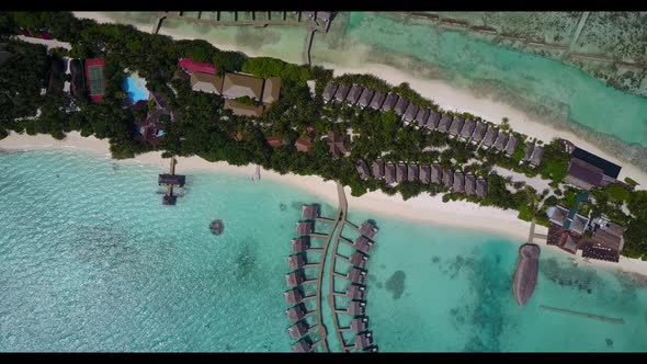 Aerial flying over texture of beautiful shore beach lifestyle by blue water with white sandy backgro