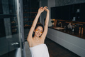 Pretty girl use under eye patches, stretching herself in kitchen after shower. Skincare treatment - PhotoDune Item for Sale