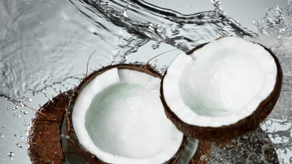 Super Slow Motion Shot of Flying Fresh Coconuts and Water Side Splash at 1000Fps.