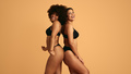 Cheerful diverse women standing back to back in studio - PhotoDune Item for Sale