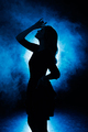 Silhouette of a girl in smoke on a blue background. - PhotoDune Item for Sale