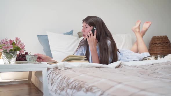 A Woman is Talking on the Phone While Lying in Bed a Woman is Drinking Coffee