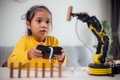 STEM education concept. Asian students learn at home by coding robot arms in STEM. - PhotoDune Item for Sale