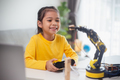 STEM education concept. Asian students learn at home by coding robot arms in STEM. - PhotoDune Item for Sale