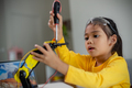 STEM education concept. Asian students learn at home by coding robot arms in STEM. - PhotoDune Item for Sale