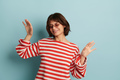 Happy young mixed race female dancing in studio - PhotoDune Item for Sale