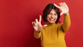 Excited Hispanic female filmmaker showing frame gesture - PhotoDune Item for Sale