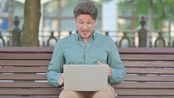 Middle Aged Man Talking on Video Call on Laptop, Outdoor