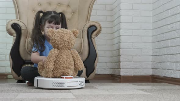 A child with a robot vacuum cleaner. 