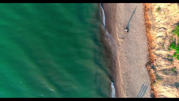 Sea waves crashing on beach. Aerial top view of sea waves break on beach