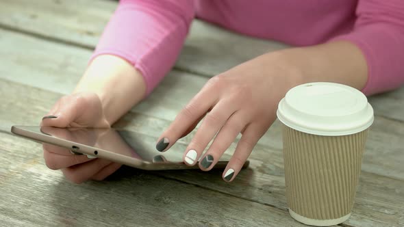 Manicured Hands Using Computer Tablet.