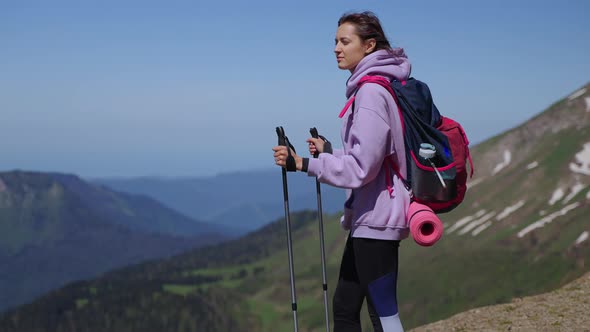 Inspired Young Woman at Top of Mount Travelling and Backpacking in Mountains