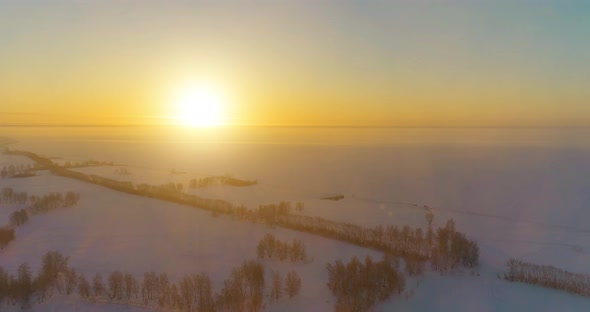 Aerial Drone View of Cold Winter Landscape with Arctic Field, Trees Covered with Frost Snow and