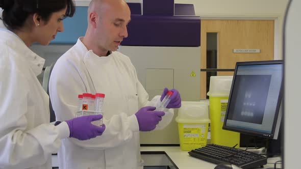 Two Scientist looking at DNA on gel image analyser