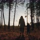 Silhouettes of a Woman and a Child Walking Through the Forest - VideoHive Item for Sale