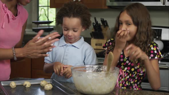 Slow motion pan of girl eating cookie dough