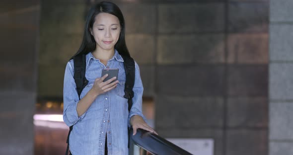 Woman use of mobile phone in city at night