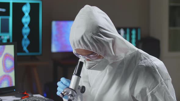 Asian Doctor In Protective Suit Working On Computer In A Modern Lab. Laboratory Assistant Workplace