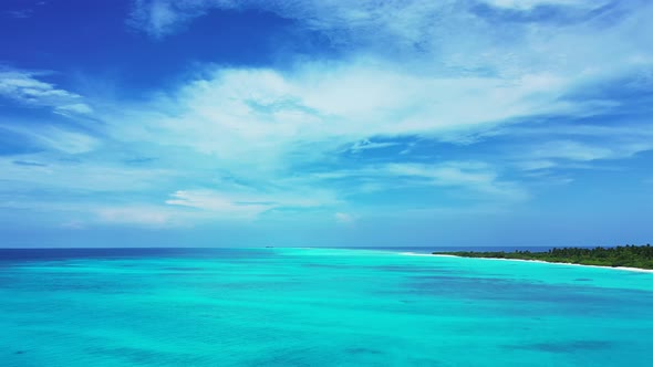 Wide flying tourism shot of a summer white paradise sand beach and turquoise sea background in vibra