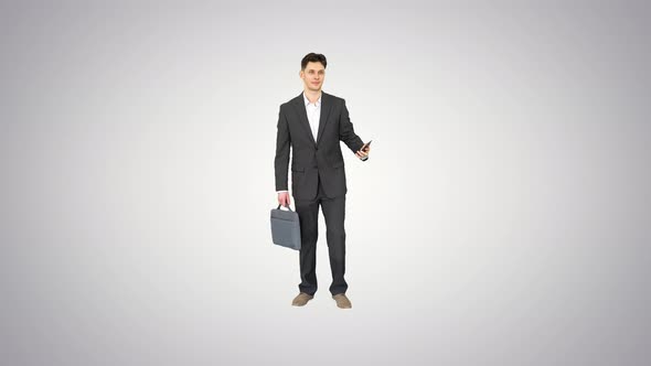 Young Businessman Taking Selfie with His Phone on Gradient Background.