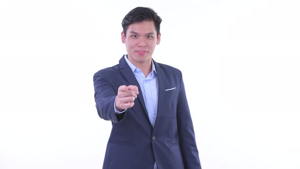 Happy Young Asian Businessman Pointing at Camera