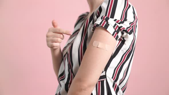 Young Woman Showing COVID19 Vaccine Bandage Merrily