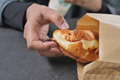  taking fresh baked croissant out from a paper packet  - PhotoDune Item for Sale