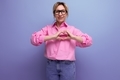 young energetic caucasian blonde secretary woman with ponytail hairstyle, glasses and in a pink - PhotoDune Item for Sale