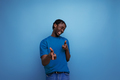 authentic ethnic african young man with dreadlocks in a casual t-shirt on a background with copy - PhotoDune Item for Sale