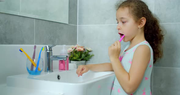 Portrait Happy Cute Young Child Brushing Teeth in Bathroom and Smiling