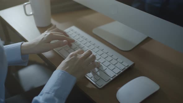 Female Typing On Computer In Office