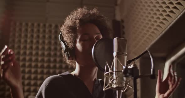 Happy Black Woman Singing Into Microphone