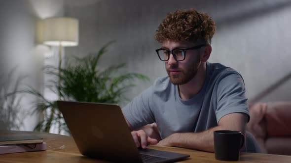 Portrait of Man Working at Night Looking at Monitor Reflections in Eyeglasses