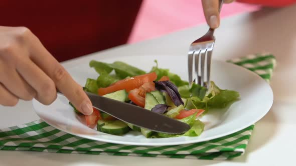 Lady Eating Fresh Vegetable Salad With Fork and Knife at Restaurant Healthy Diet