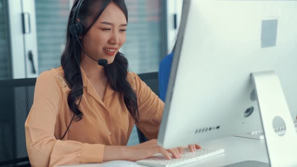 Businesswoman Wearing Headset Working Actively in Office