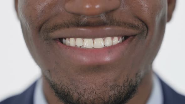 Close Up of Smiling Lips of African Man alt