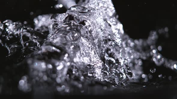 Super Slowmotion Shot of Pouring Water Against Black at 1000Fps
