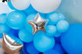 Close-up of multicolored latex balloons with silver stars. Holiday decor. - PhotoDune Item for Sale