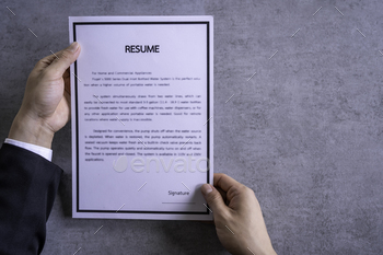 den table, Businessman Reading holding resume application, top view
