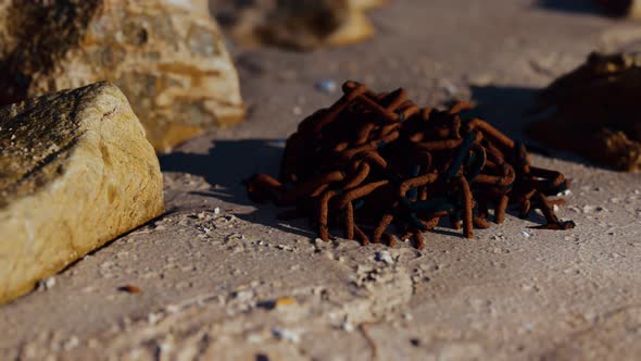 Old Rusted Abandoned Chain on Sand Beach