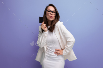 portrait of successful young business woman proudly standing with money card with salary