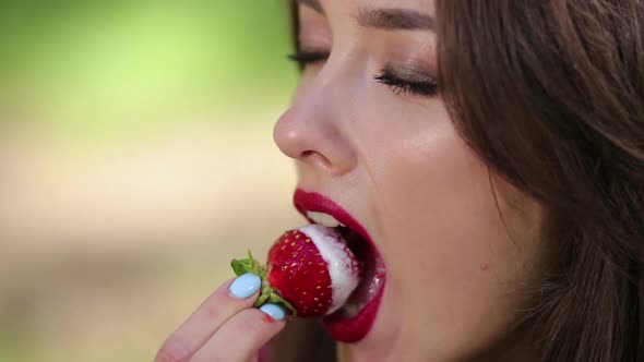 Pretty Woman Seductively Eating Strawberries