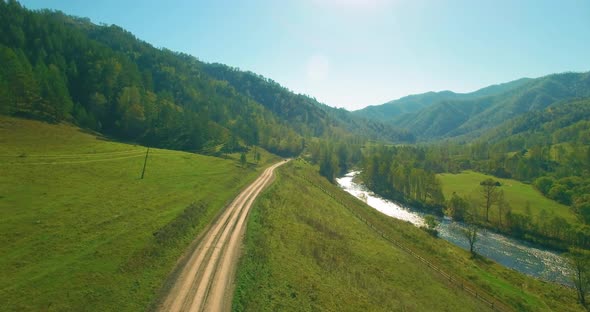 Low Altitude Flight Over Fresh Fast Mountain River with Rocks at Sunny Summer Morning