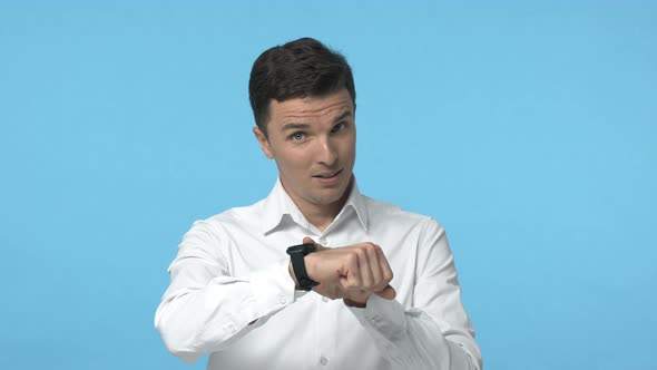 Slowmotion Handsome Businessman in White Shirt Pointing at Watch and Tapping It Implying Move Faster