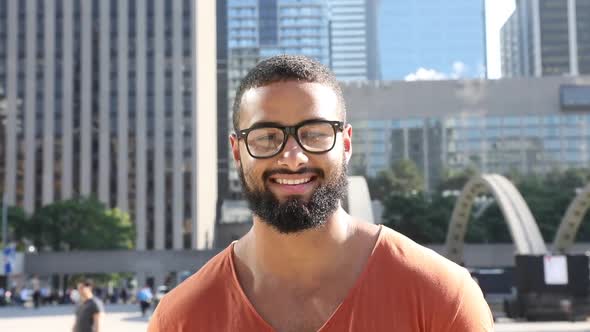 Black man portrait, smiling in the city